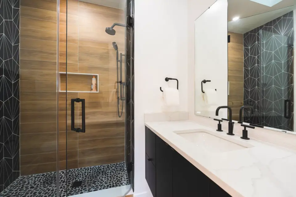 Bathroom with a wood-look tile shower and black hexagon tile