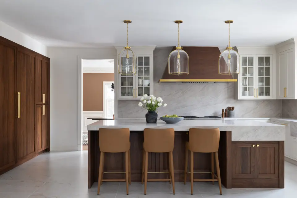 The kitchen straight on, white glass-front uppers either side of the hood
