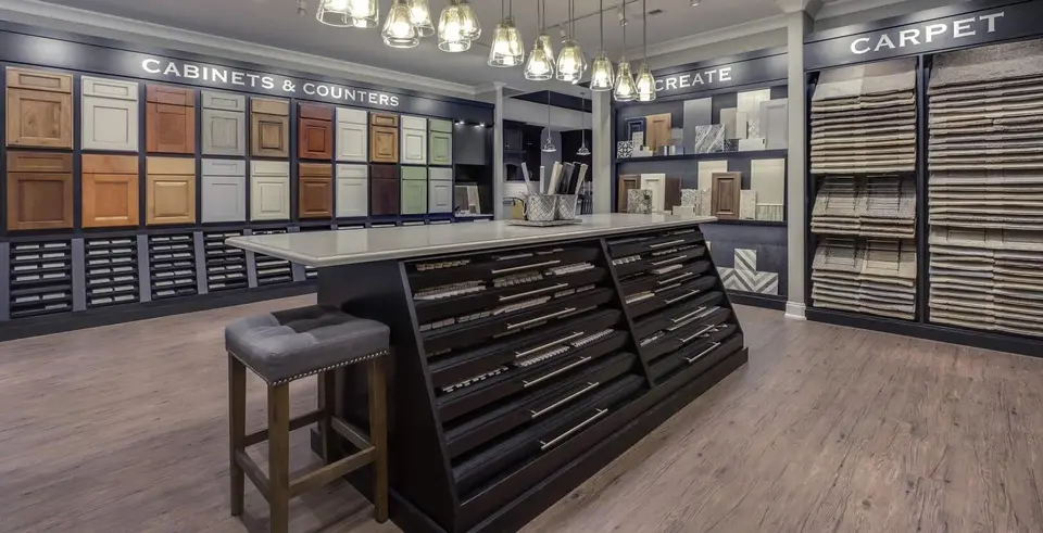 Inside the Boss Design Center showroom: a wall of cabinet door samples, countertop samples and a hardware display